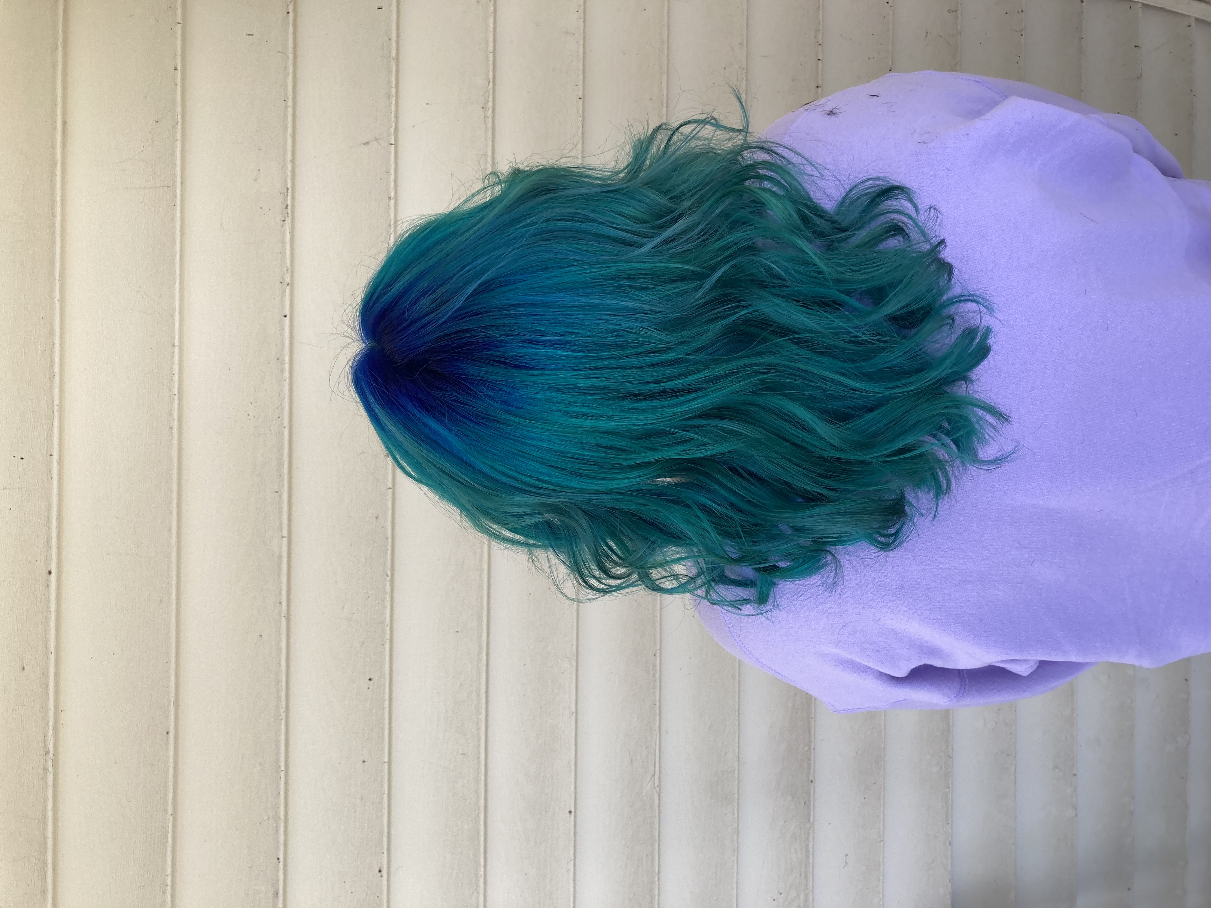 Dyed and styled teal with blue roots.