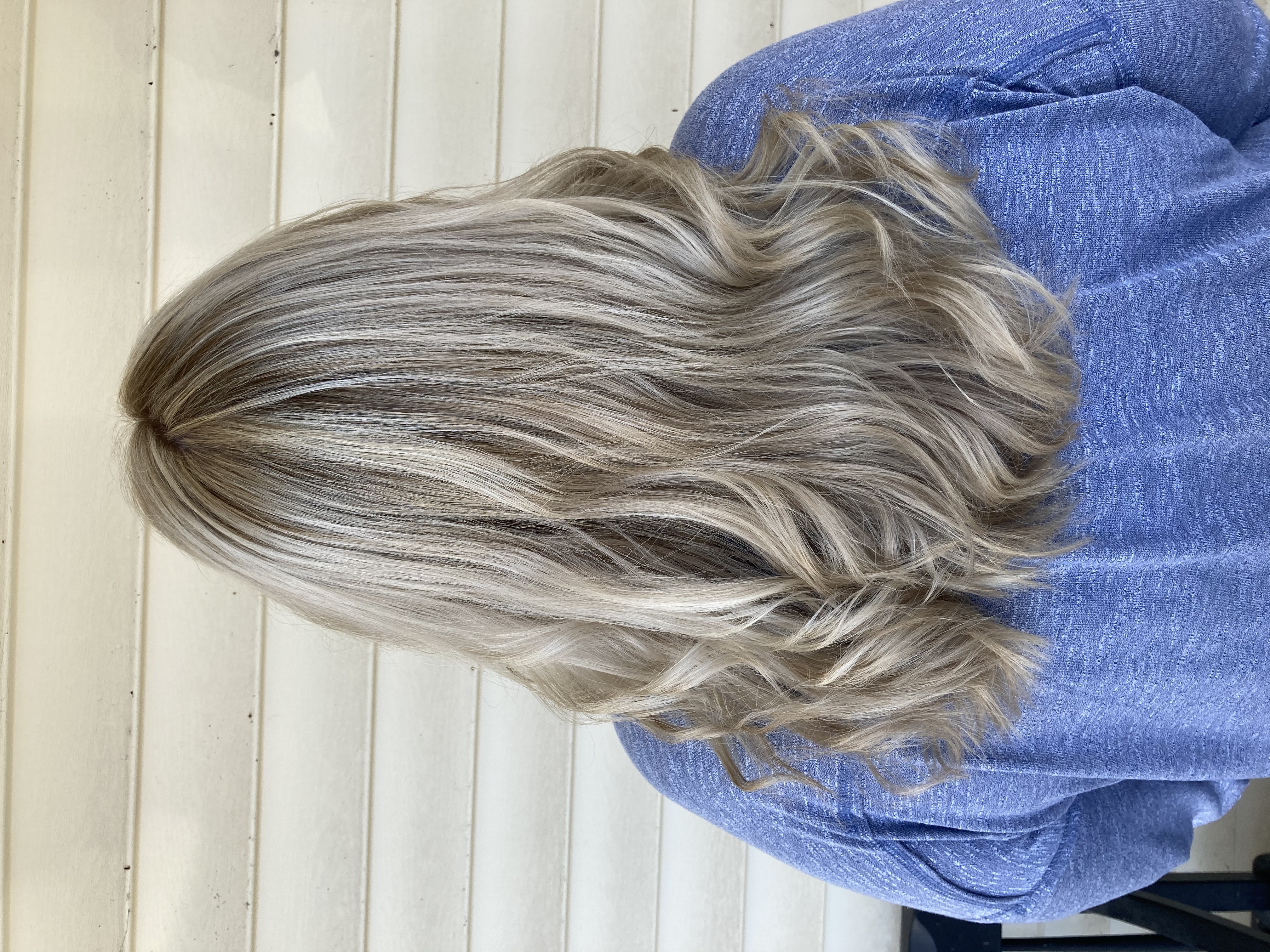 Dyed and styled blonde with brown roots.