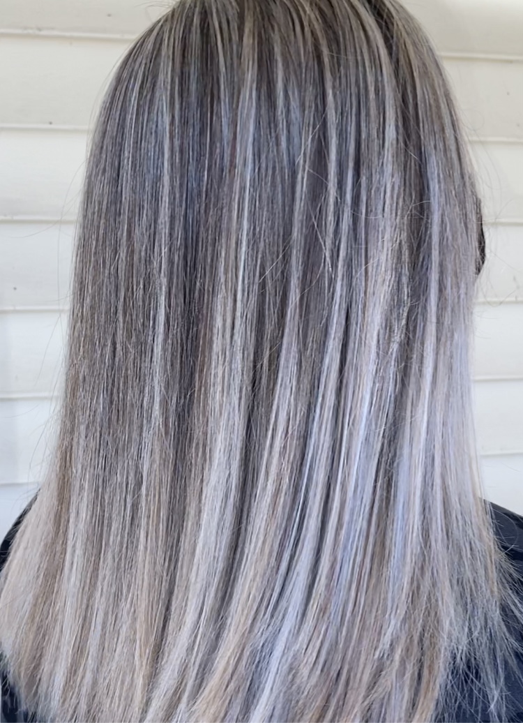 Dyed and styled blonde and gray highlights.