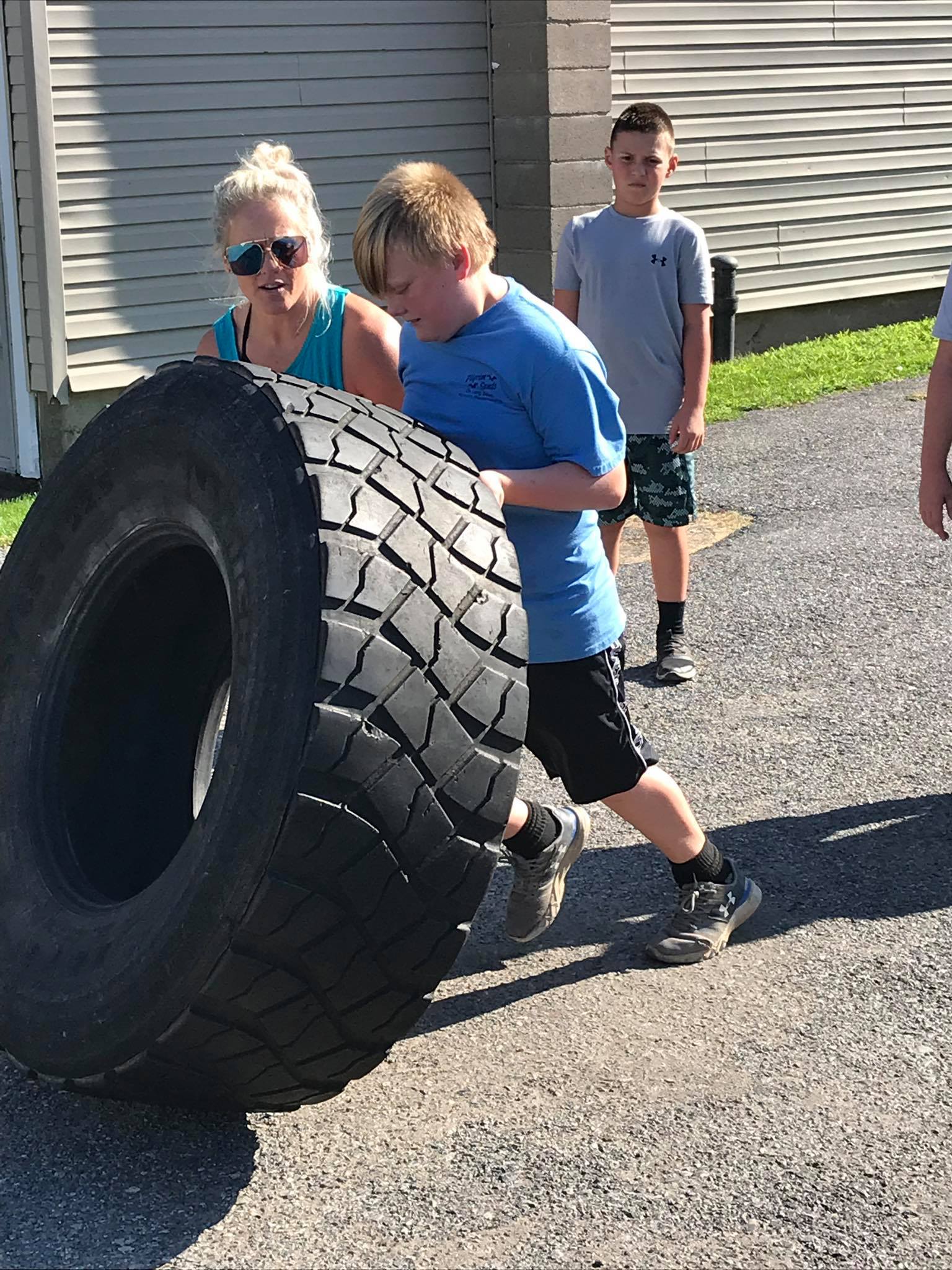 Kids lifting tire