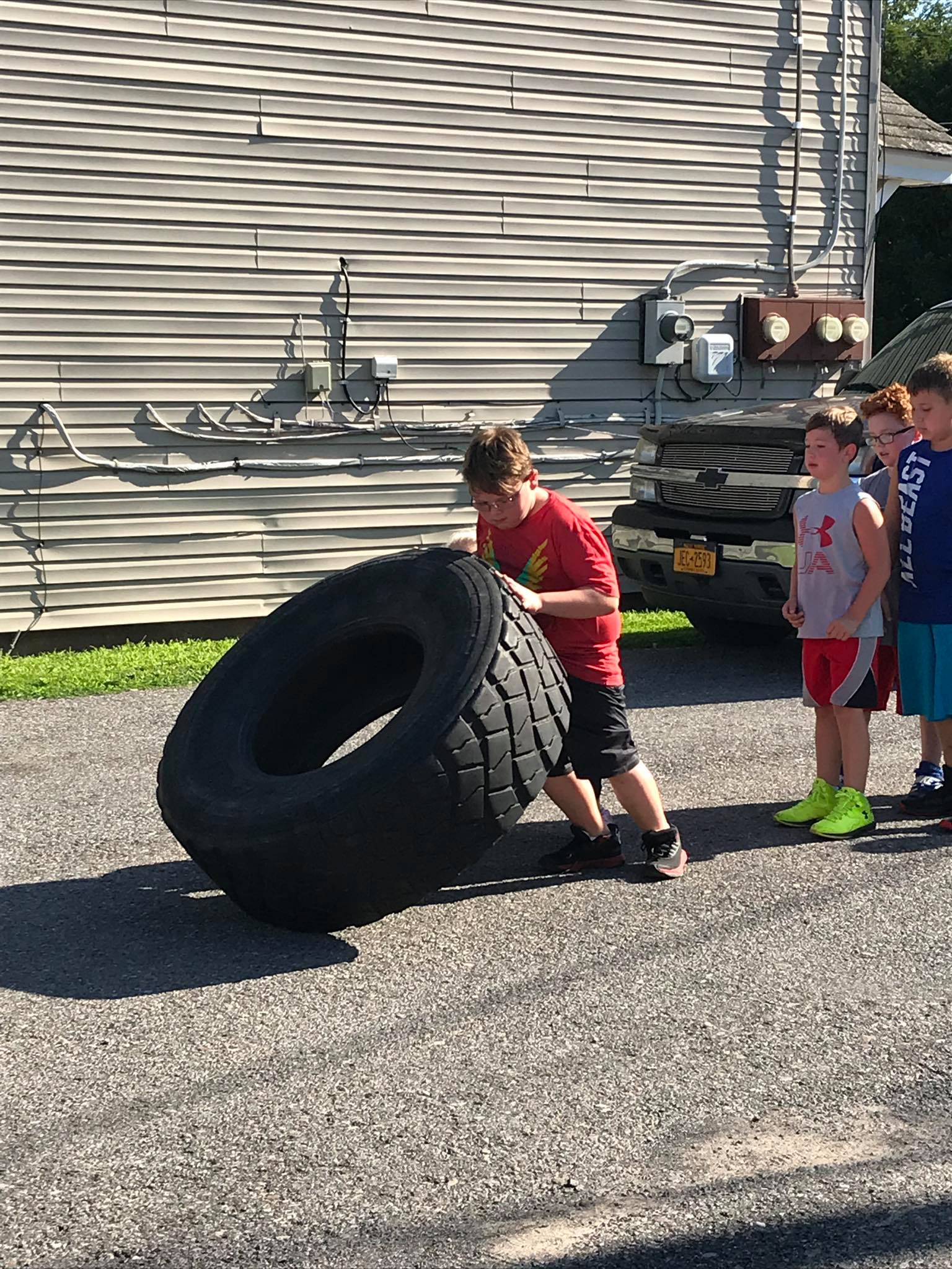 Kids lifting tire