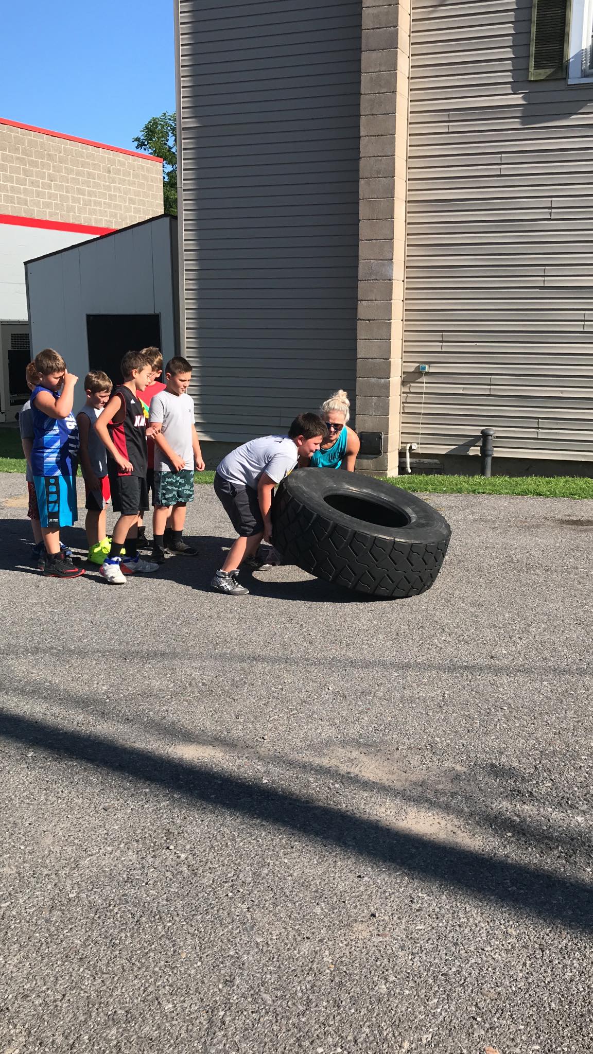 Kids lifting tire